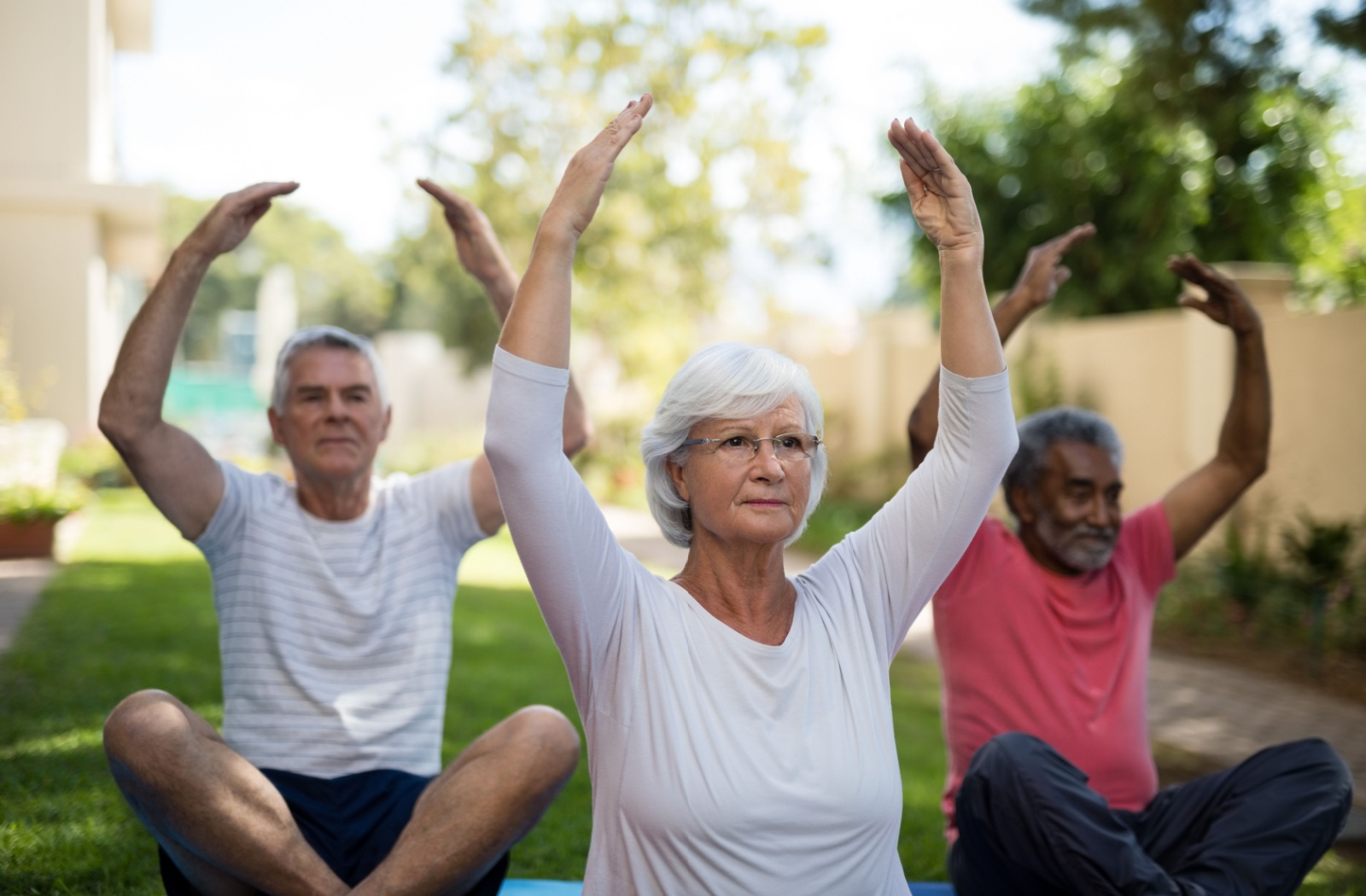 A senior participates in a group fitness class during their short-term stay in a senior community.