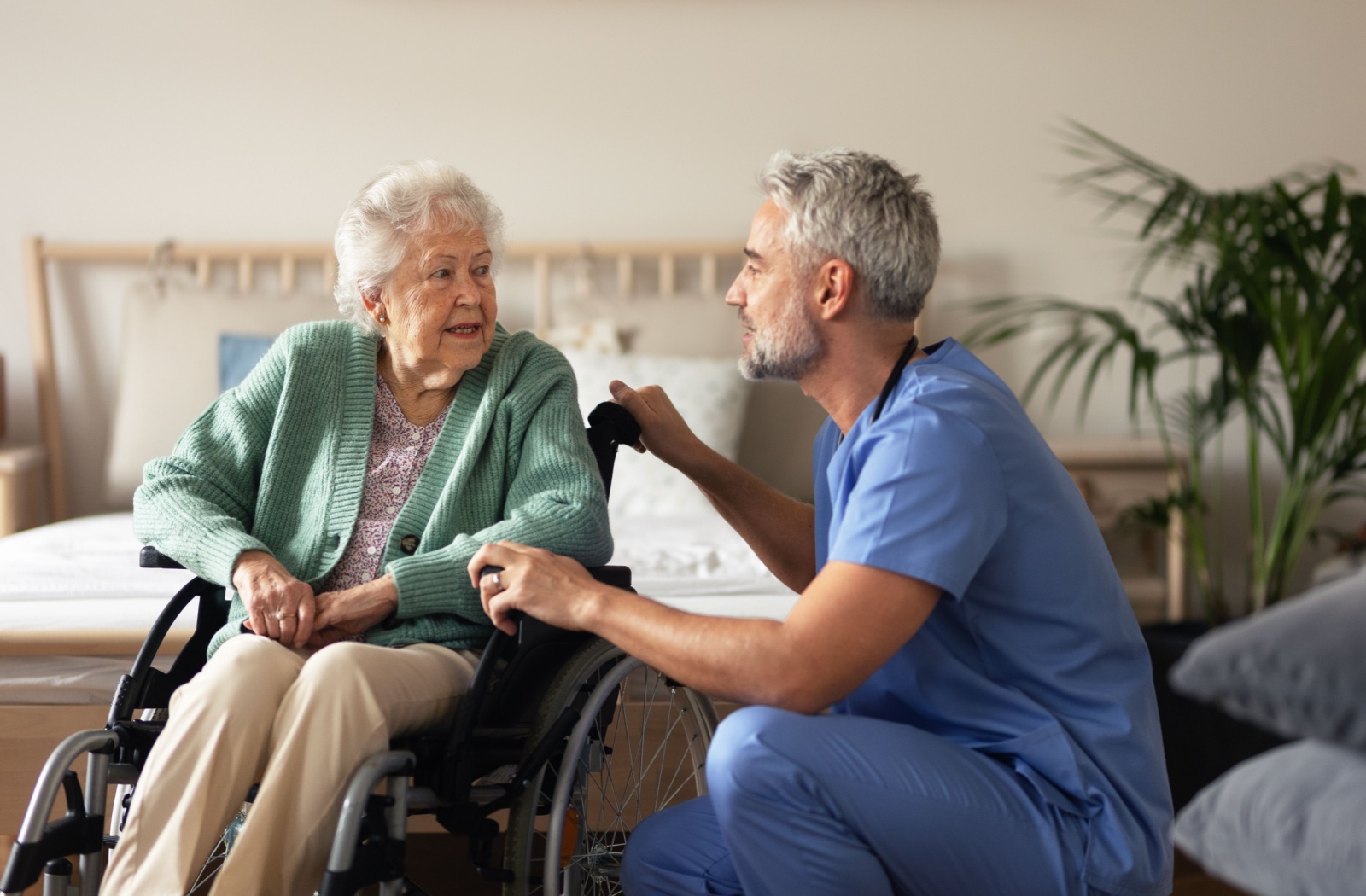 Older adult speaking with a caregiver