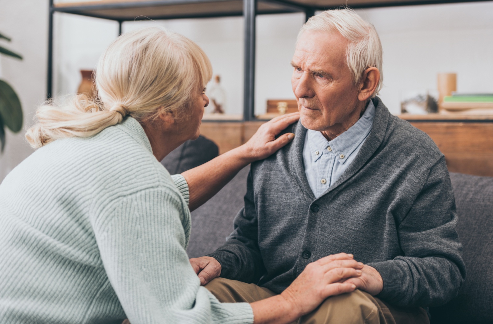 A senior comforts their senior spouse with MCI.